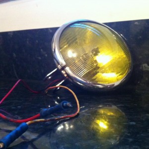 Refurbished vintage headlight,complete with yellow film tint..