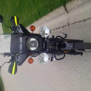 Front view showing Shoei FM2 fairing with tall windshield; BarkBuster Storm hand guards with reflective Hi-Vis accents and LED strips for markers and