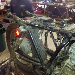 Stripped to frame engine and harness.Tom has started moddin the framework